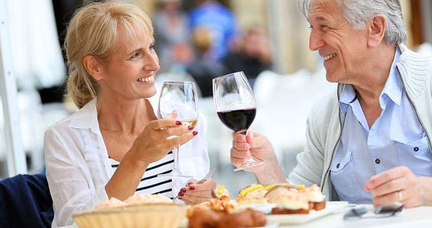 Mature couple toasting during lunch at Spanish restaurant