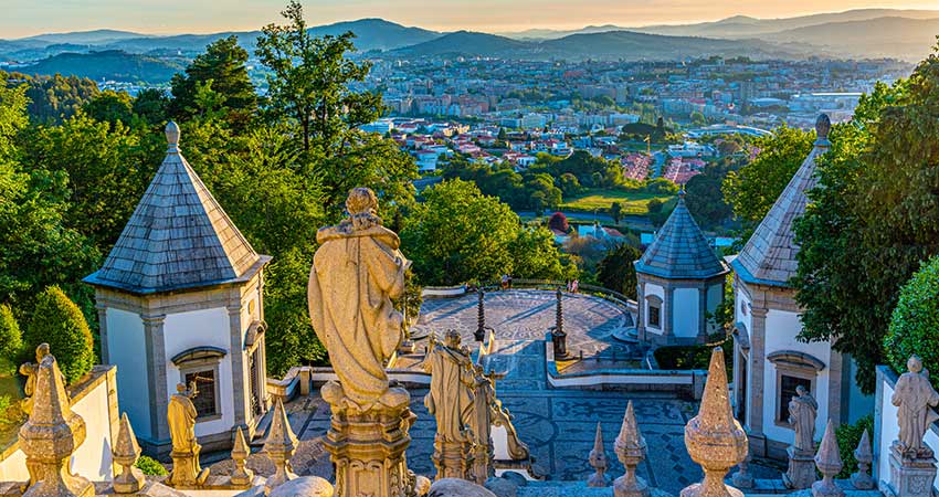 Religious statues overlooking the city of Braga during sunset